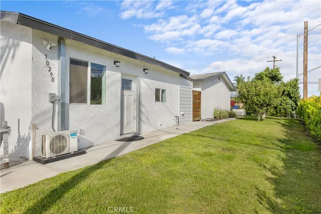 a backyard of a house with table and chairs