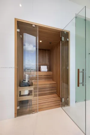 a en suite bathroom with a sink and a large mirror