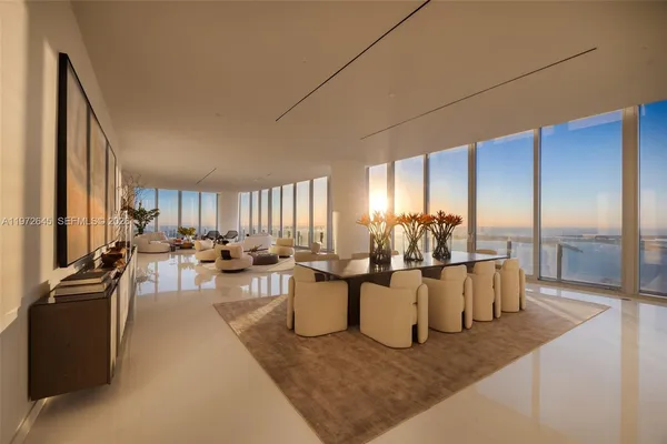 a living room with furniture and large windows