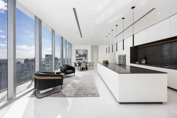 a living room with furniture a flat screen tv and a large window