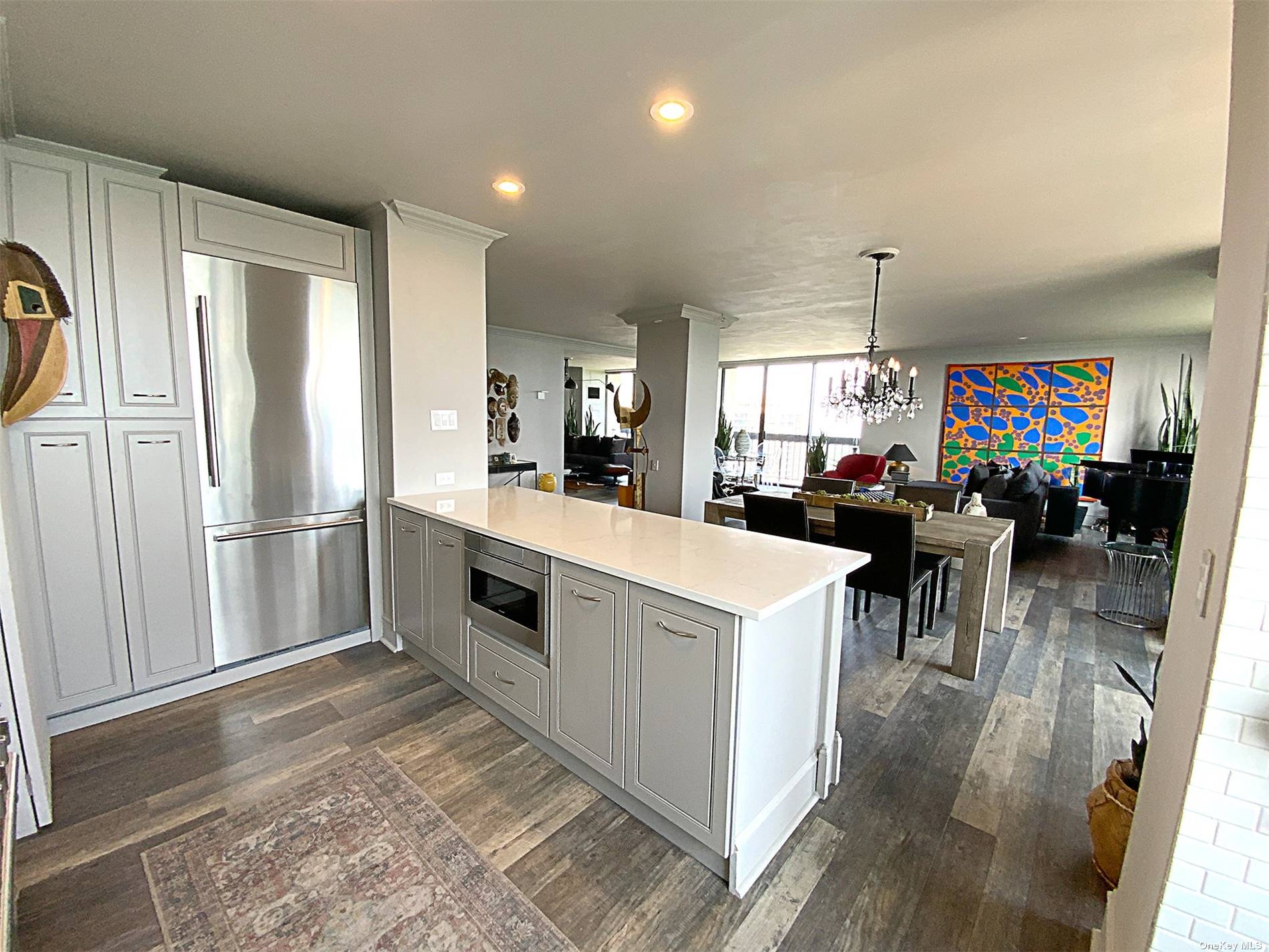 a kitchen with stainless steel appliances a refrigerator a sink a stove and a center island