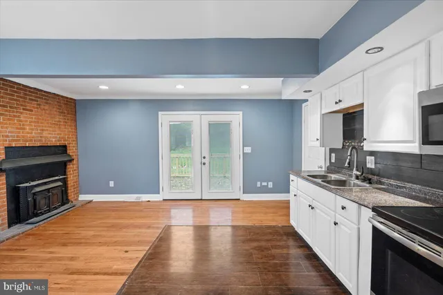 a large kitchen with stainless steel appliances granite countertop a stove sink and cabinets