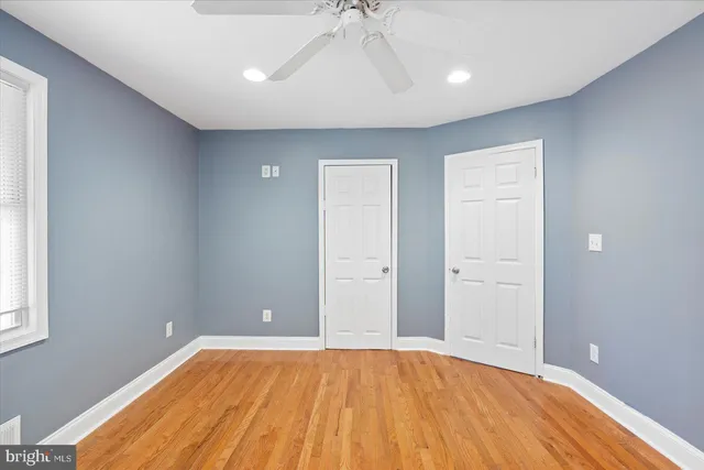 a view of room with window and wooden floor