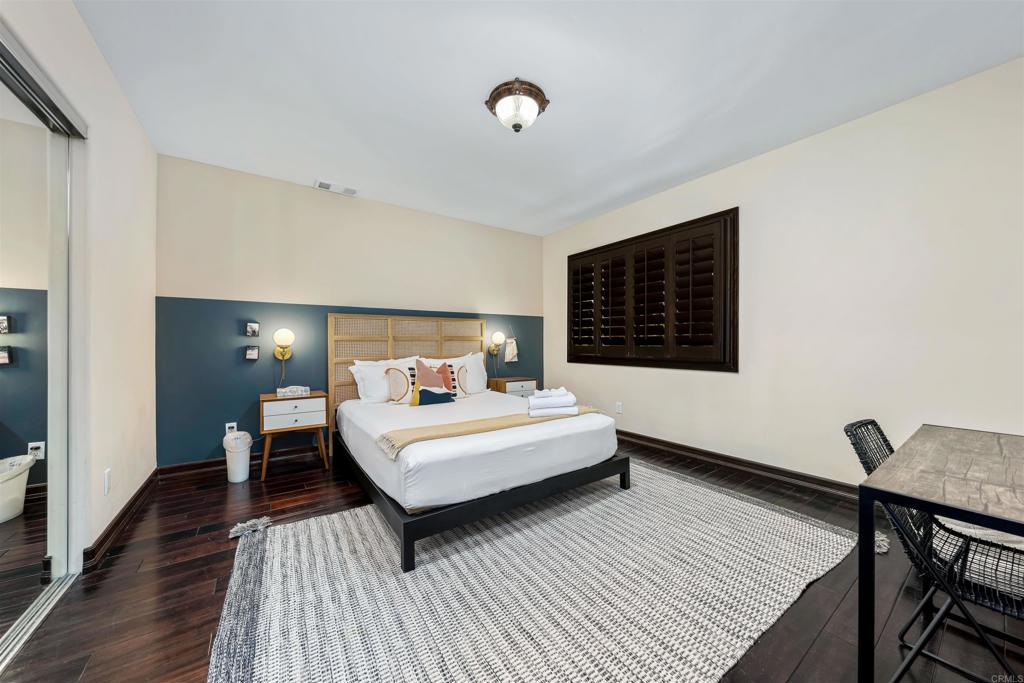 5765 Soledad Mountain Road La Jolla, CA 92037 - Photo 11 of 22 a bedroom with a bed and wooden floor