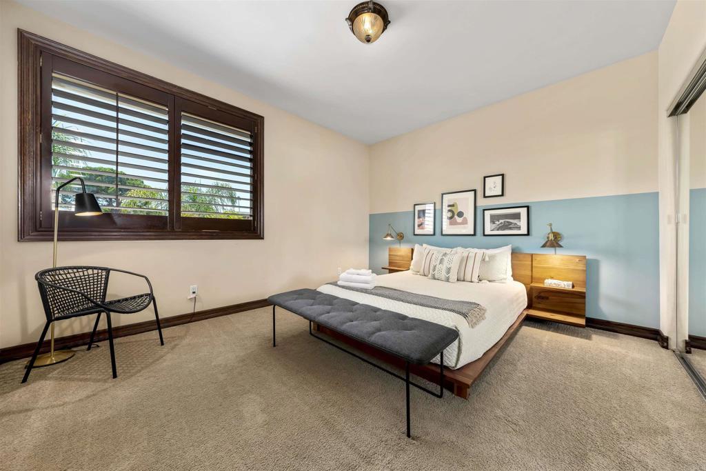 5765 Soledad Mountain Road La Jolla, CA 92037 - Photo 14 of 22 a bedroom with a bed chair and window