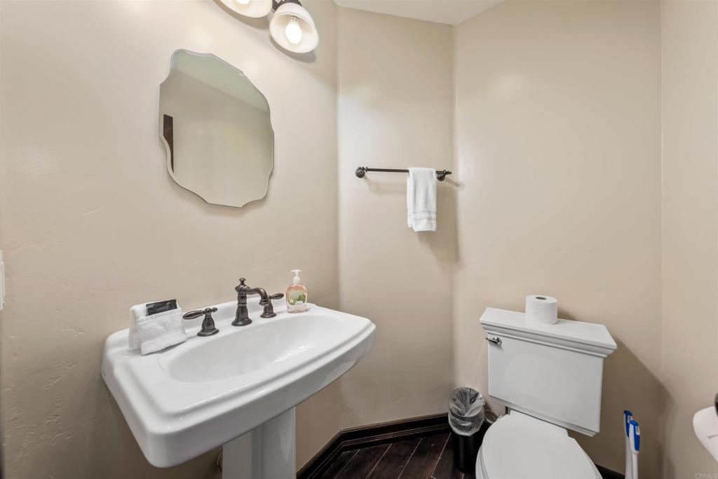 5765 Soledad Mountain Road La Jolla, CA 92037 - Photo 17 of 22 a bathroom with a sink a toilet and a mirror