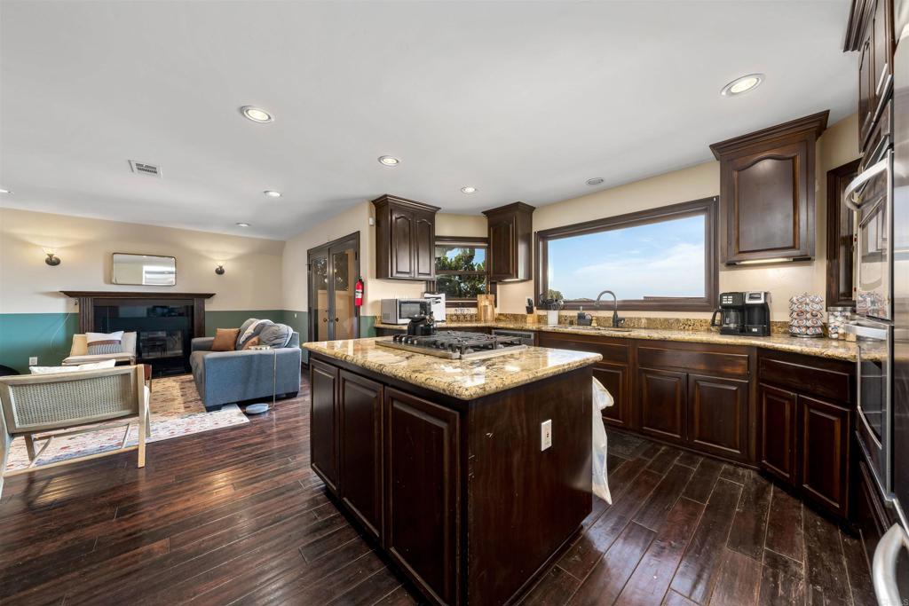 5765 Soledad Mountain Road La Jolla, CA 92037 - Photo 4 of 22 a kitchen with a stove and a wooden floor