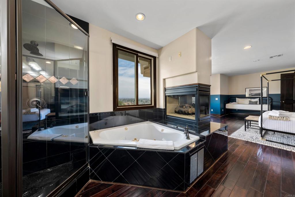 5765 Soledad Mountain Road La Jolla, CA 92037 - Photo 9 of 22 a living room with stainless steel appliances a fireplace a flat screen tv and a table