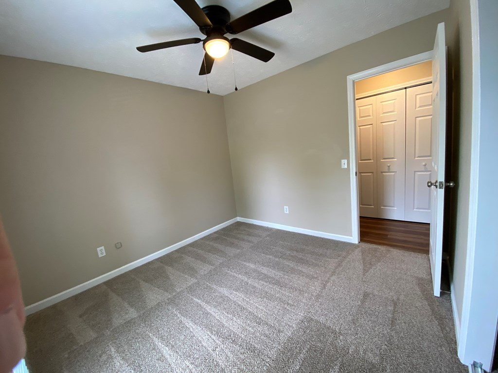 3 Deland Court Columbus, GA 31904 - Photo 15 of 27 an empty room with a ceiling fan and carpet