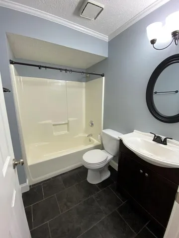 a bathroom with a toilet sink vanity tub and shower