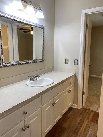a bathroom with a sink and two mirror