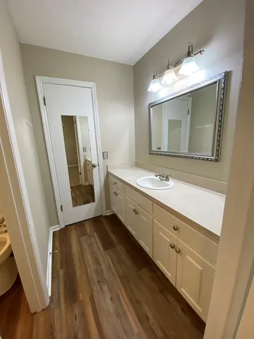 a bathroom with a double vanity sink and mirror
