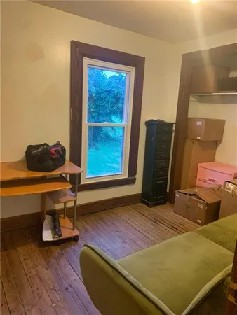 a living room with a couch and wooden floor