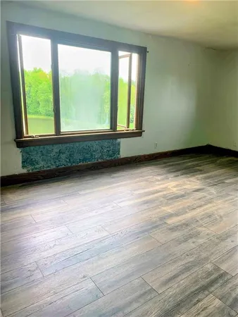 a view of a hallway with wooden floor and stairs