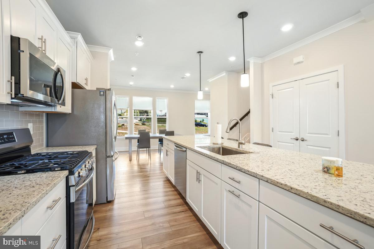 3027 Coriander Place Bryans Road, MD 20616 - Photo 12 of 29 a kitchen with granite countertop a sink a counter space appliances and cabinets