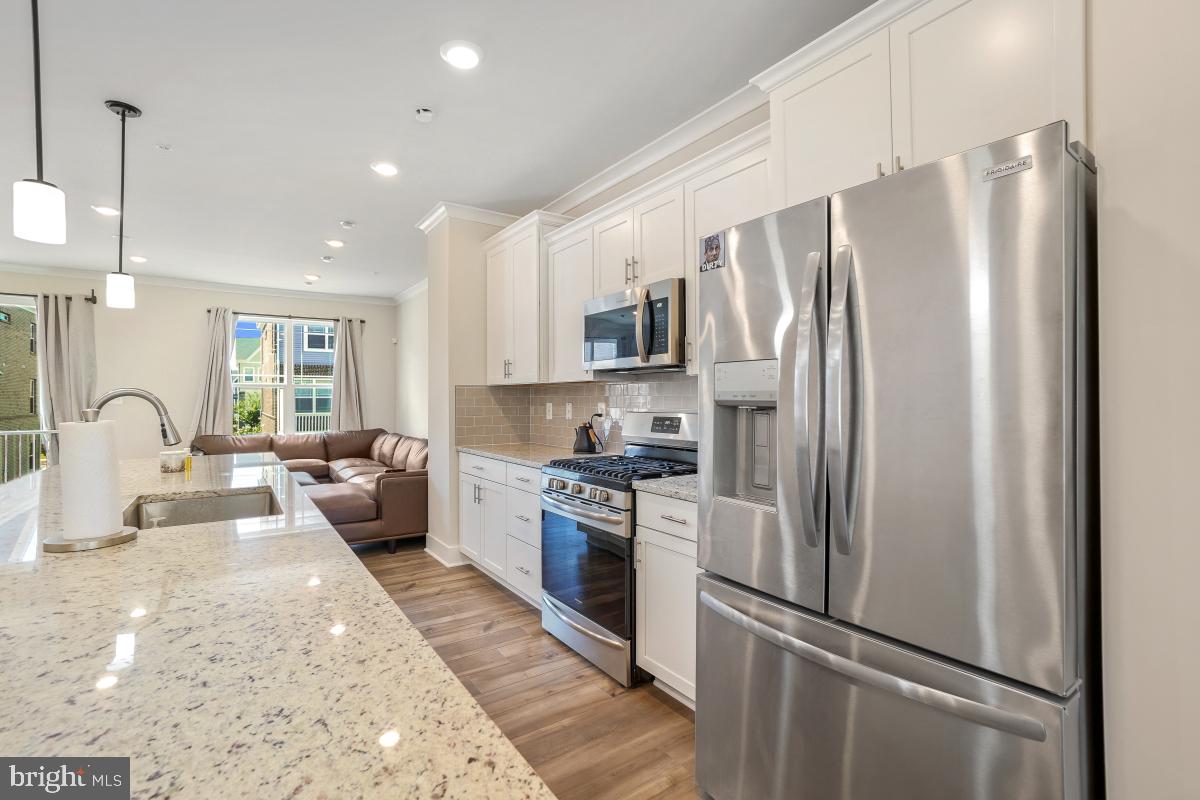 3027 Coriander Place Bryans Road, MD 20616 - Photo 15 of 29 a large kitchen with stainless steel appliances granite countertop a refrigerator stove microwave and sink