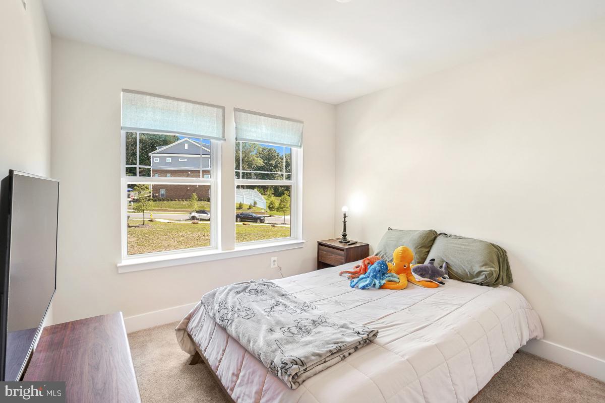 3027 Coriander Place Bryans Road, MD 20616 - Photo 26 of 29 a bedroom with a bed and wooden floor