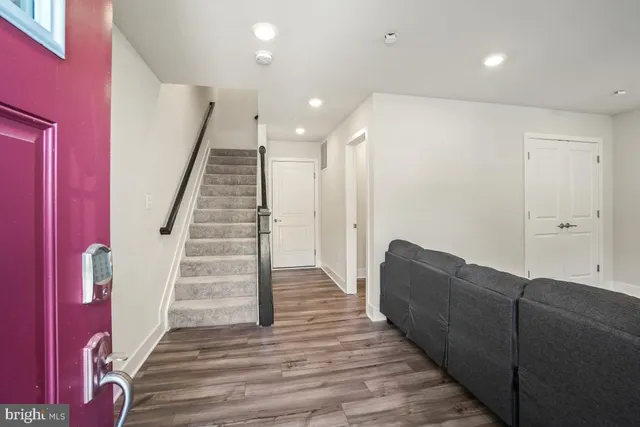 a living room with furniture and stairs