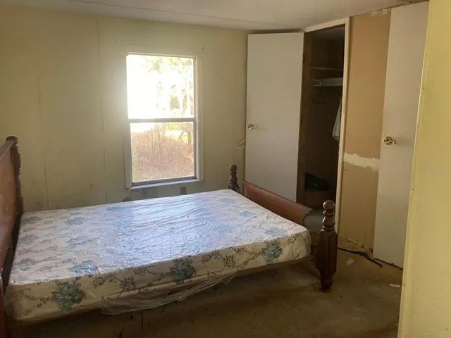 a bedroom with a bed and a window