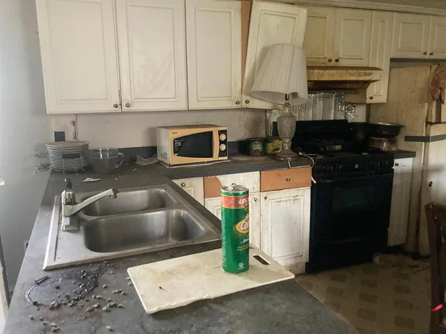 a kitchen with a sink and a stove top oven