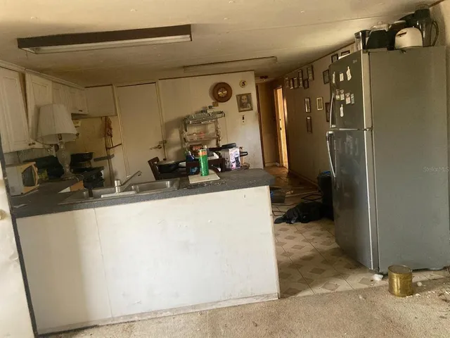 a close view of a faucet a sink and cabinets