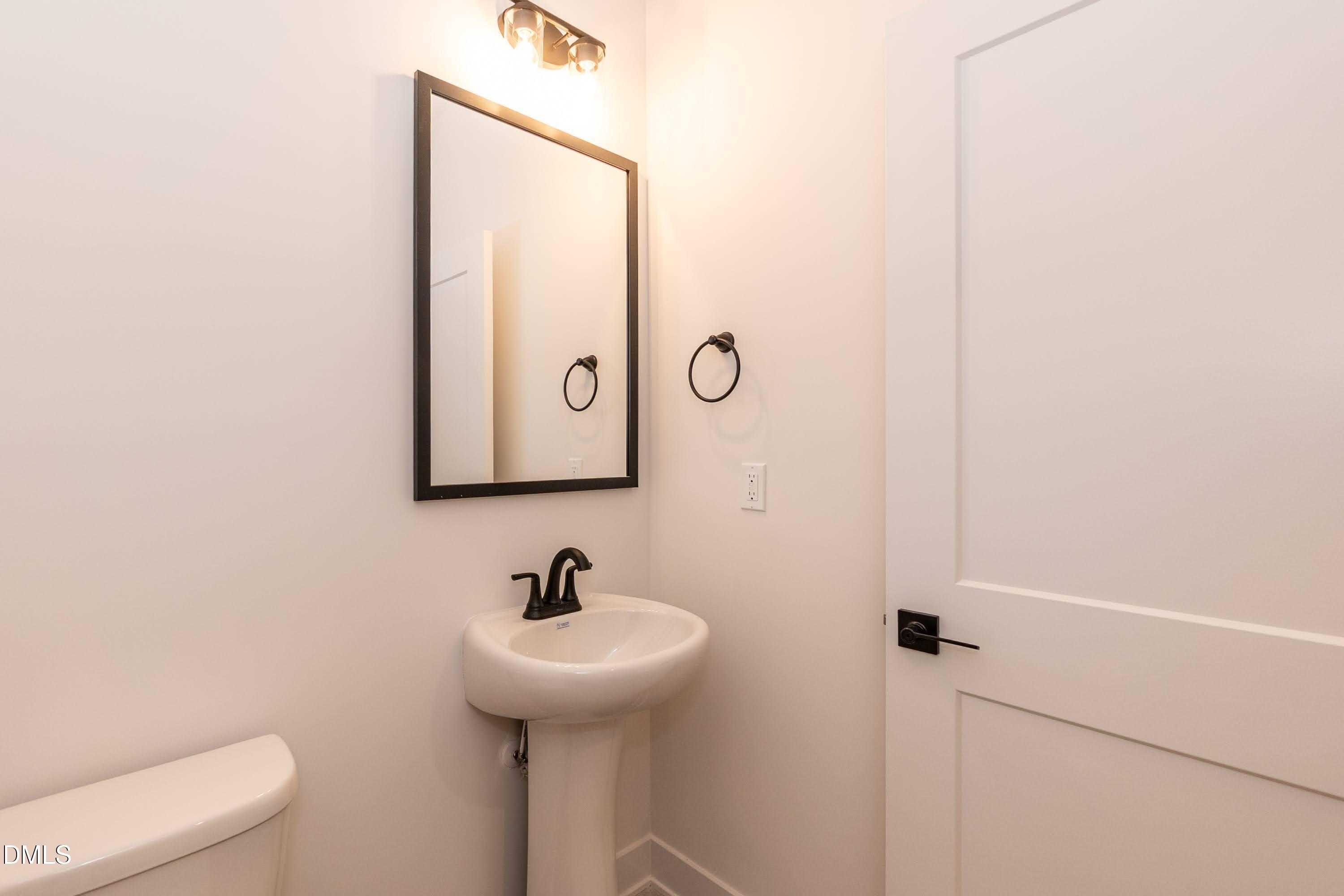 180 Galway Road Lillington, NC 27546 - Photo 32 of 41 a bathroom with a sink and mirror with toilet