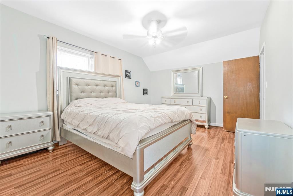 78 Columbia Street Wood-Ridge, NJ 07075 - Photo 14 of 25 a bedroom with a bed and a chandelier