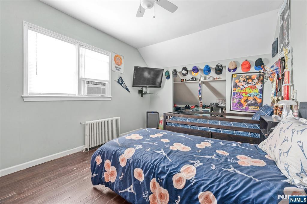 78 Columbia Street Wood-Ridge, NJ 07075 - Photo 16 of 25 a bedroom with a bed and a flat screen tv