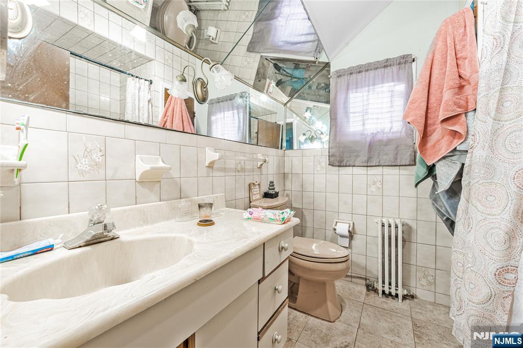 78 Columbia Street Wood-Ridge, NJ 07075 - Photo 17 of 25 a bathroom with a sink and mirror with toilet