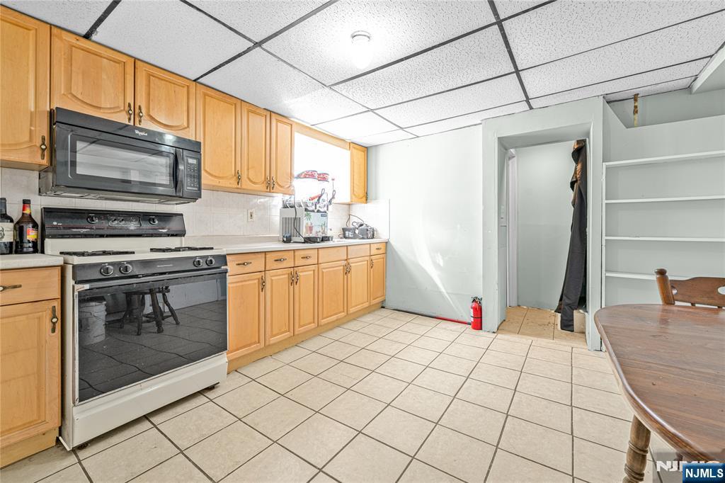 78 Columbia Street Wood-Ridge, NJ 07075 - Photo 19 of 25 a kitchen with stainless steel appliances kitchen island granite countertop a refrigerator and stove