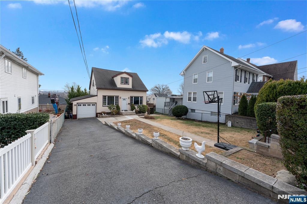 78 Columbia Street Wood-Ridge, NJ 07075 - Photo 2 of 25 a front view of a house with a yard