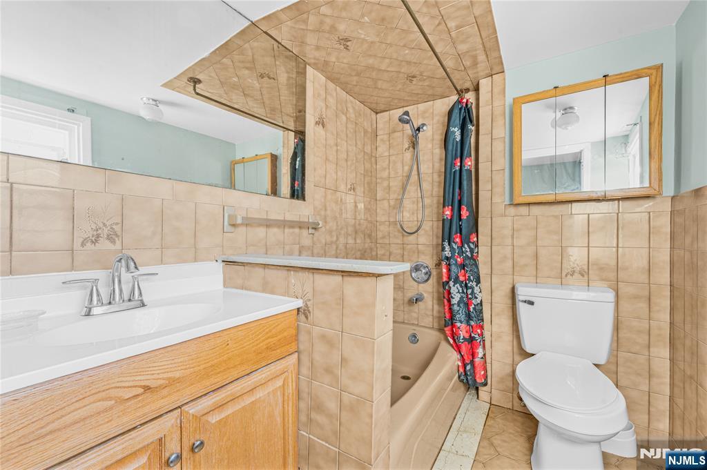 78 Columbia Street Wood-Ridge, NJ 07075 - Photo 10 of 25 a white toilet sitting next to a bathroom sink