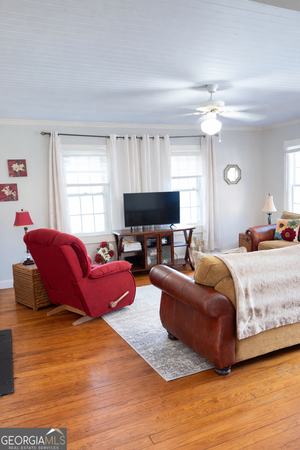 223 Holt Street Thomson, GA 30824 - Photo 12 of 24 a living room with furniture window and a flat screen tv