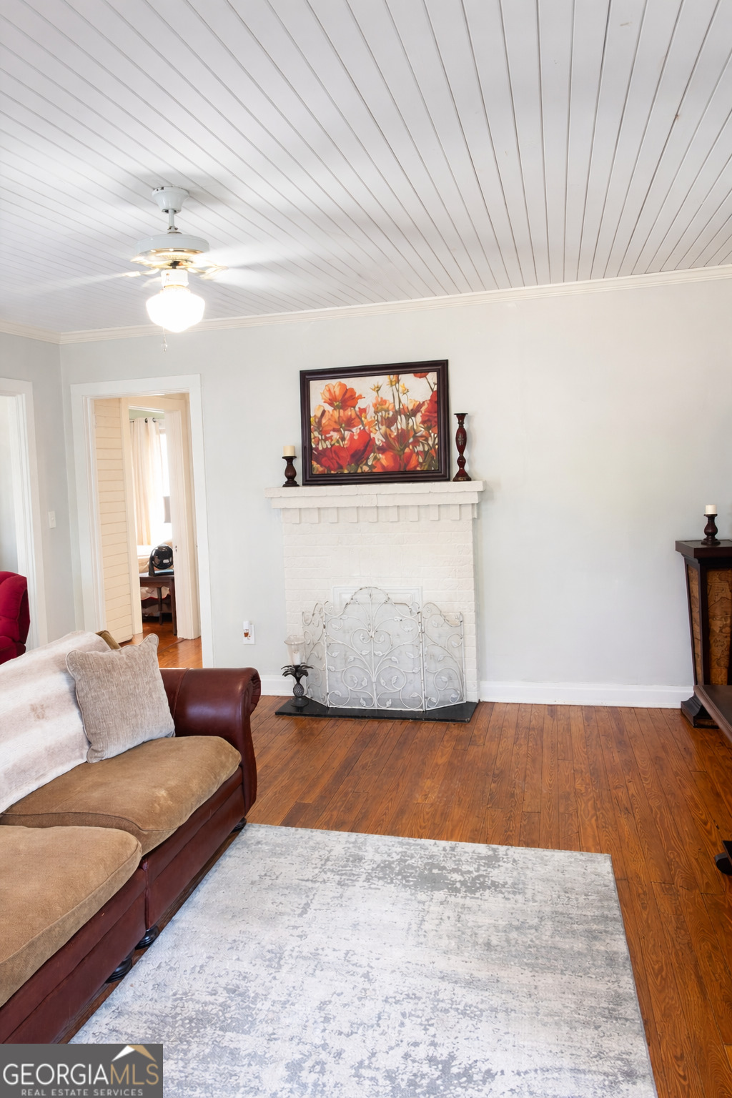 223 Holt Street Thomson, GA 30824 - Photo 13 of 24 a living room with furniture and a flat screen tv