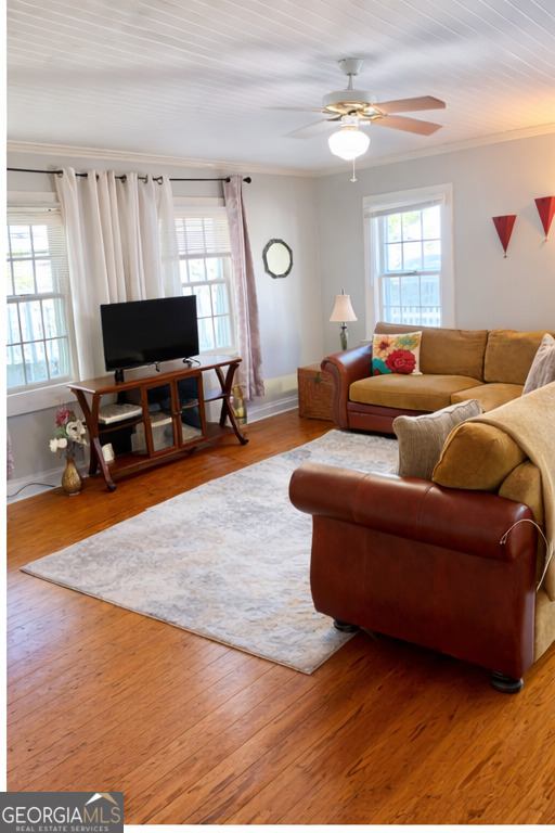 223 Holt Street Thomson, GA 30824 - Photo 14 of 24 a living room with furniture a fireplace and a flat screen tv