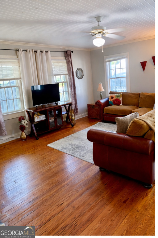 223 Holt Street Thomson, GA 30824 - Photo 15 of 24 a living room with furniture and a flat screen tv