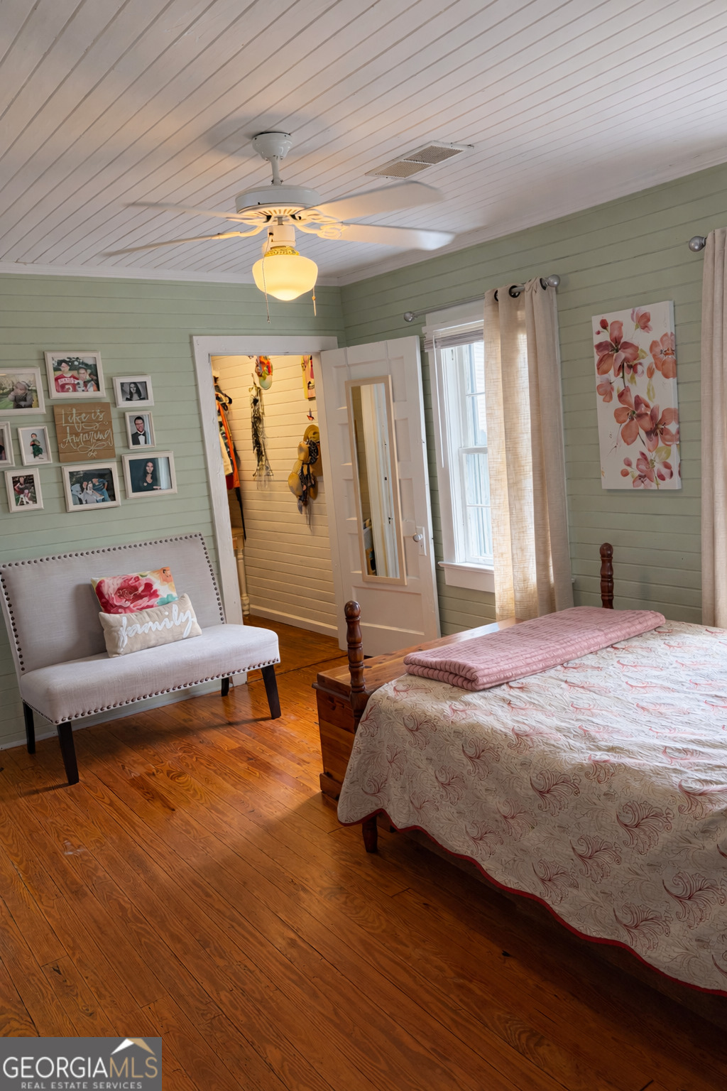 223 Holt Street Thomson, GA 30824 - Photo 16 of 24 a bedroom with a bed and a window