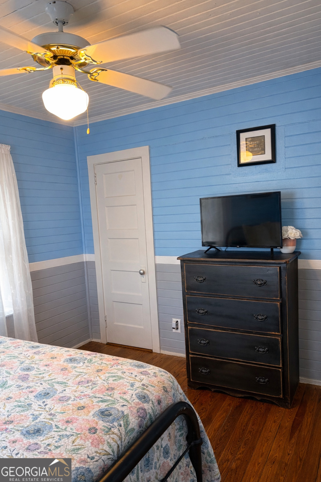 223 Holt Street Thomson, GA 30824 - Photo 19 of 24 a bedroom with a bed and a chandelier