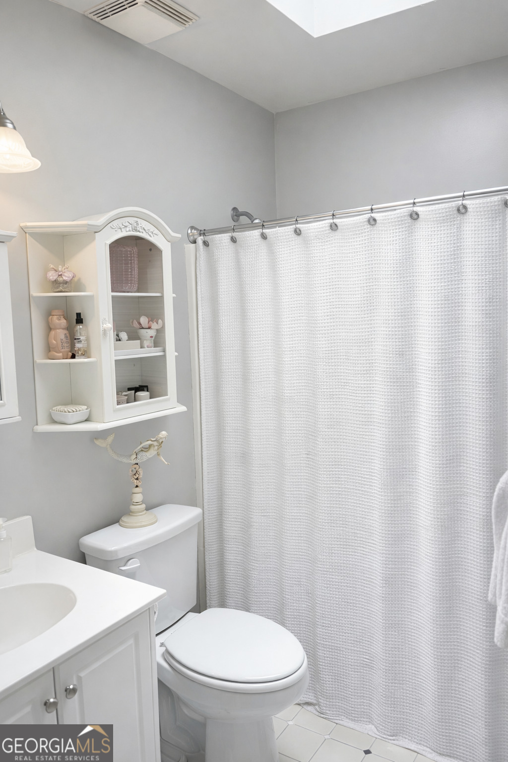 223 Holt Street Thomson, GA 30824 - Photo 21 of 24 a bathroom with a sink a toilet and a mirror