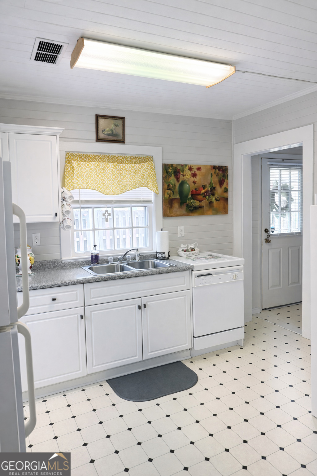223 Holt Street Thomson, GA 30824 - Photo 5 of 24 a kitchen with a sink a stove and white cabinets