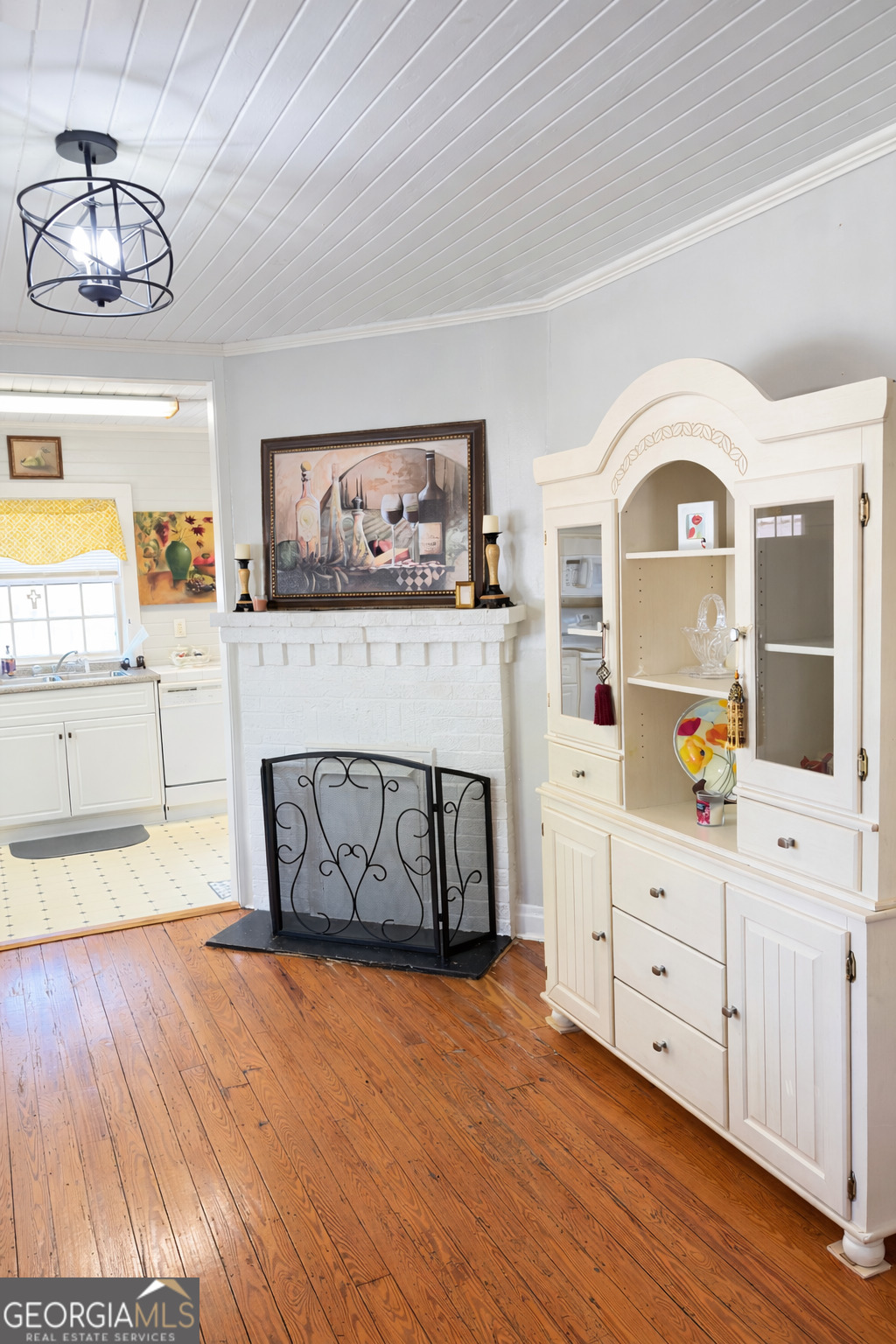 223 Holt Street Thomson, GA 30824 - Photo 7 of 24 a view of a kitchen with furniture and wooden floor