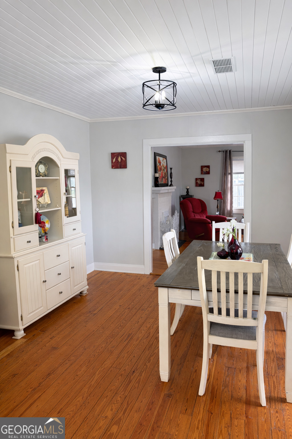 223 Holt Street Thomson, GA 30824 - Photo 9 of 24 a view of a dining room with furniture and wooden floor