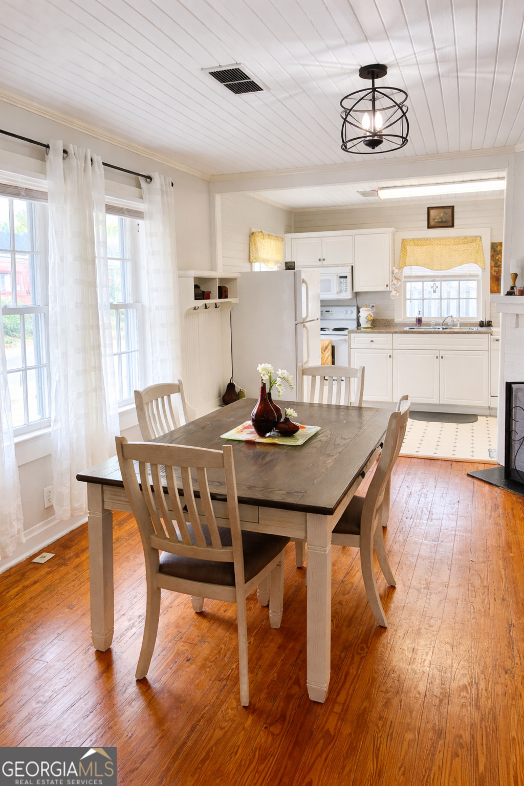 223 Holt Street Thomson, GA 30824 - Photo 10 of 24 a dining room with furniture and wooden floor
