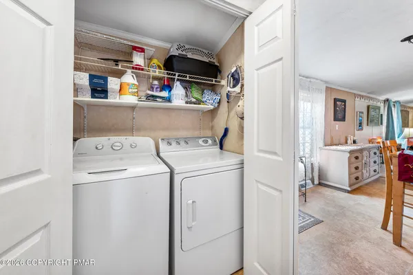 a view of storage and utility room with washer and dryer