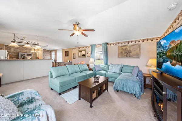 a living room with furniture and a flat screen tv