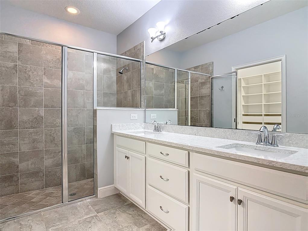 5644 Estero Loop Port Orange, FL 32128 - Photo 18 of 50 a bathroom with a shower sink and mirror