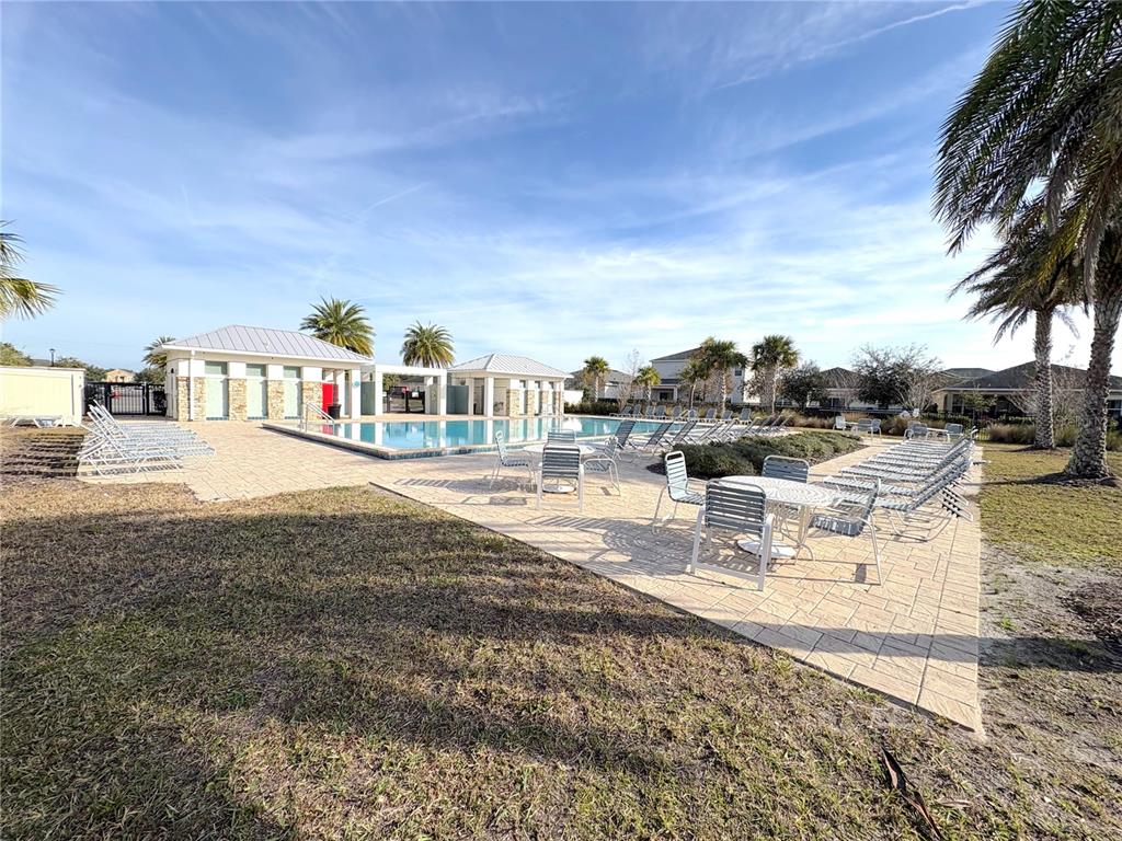 5644 Estero Loop Port Orange, FL 32128 - Photo 49 of 50 a view of swimming pool with outdoor seating and plants