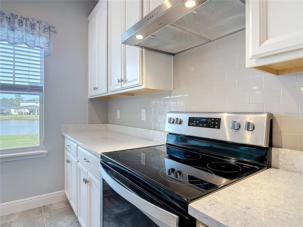 5644 Estero Loop Port Orange, FL 32128 - Photo 5 of 50 a kitchen with a stove a sink and a window