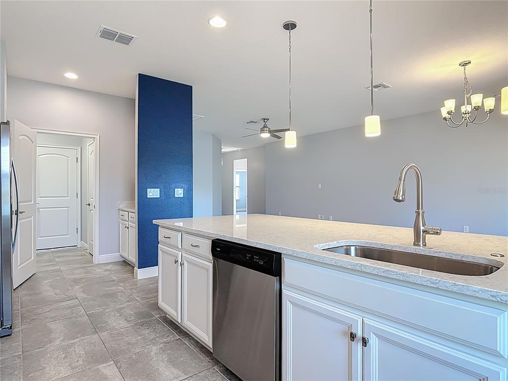 5644 Estero Loop Port Orange, FL 32128 - Photo 6 of 50 a kitchen with a sink and chandelier