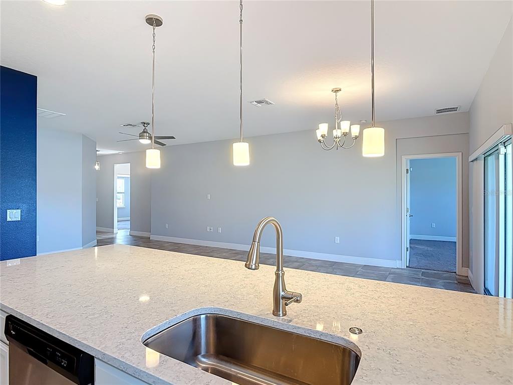 5644 Estero Loop Port Orange, FL 32128 - Photo 7 of 50 a kitchen with a sink and chandelier